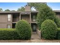 Condominium exterior with a walkway leading to the front door, surrounded by mature bushes at 507 Embers Se Dr, Marietta, GA 30067