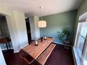 Charming dining room with modern light fixture, wood table, and large window with natural light at 1369 Star Water Dr, Lawrenceville, GA 30045