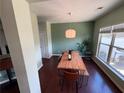 Charming dining room with modern light fixture, wood table, and large window with natural light at 1369 Star Water Dr, Lawrenceville, GA 30045
