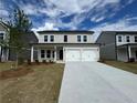 Attractive two-story home featuring a spacious driveway and manicured lawn at 2101 Boxwood Circle Se, Conyers, GA 30094