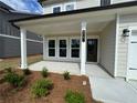 Inviting front porch with stylish columns and ample space, leading to the front door at 2101 Boxwood Circle Se, Conyers, GA 30094