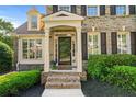 Inviting front porch with brick steps and trim details, leading to a screened door entry at 4876 Sara Creek Way, Sugar Hill, GA 30518