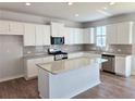 Modern kitchen featuring stainless appliances, granite countertops, and white cabinetry at 680 Redhead Way(Lot 22), Grayson, GA 30017