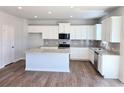 Modern kitchen featuring stainless appliances, granite countertops, and white cabinetry at 680 Redhead Way(Lot 22), Grayson, GA 30017
