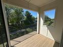 Open-air balcony boasting light wood-look flooring and black metal railing at 127 Stein Steel Street # 112, Atlanta, GA 30316