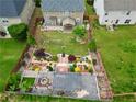 Aerial view of fenced backyard with beautiful garden, patio, play set, and mature trees at 4195 Settlers Grove Rd, Cumming, GA 30028