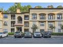Elegant exterior of a multi-story apartment building with parking and manicured landscaping in a well-maintained community at 3777 Peachtree Ne Rd # 412, Brookhaven, GA 30319
