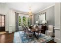 Beautiful dining room featuring a large window, stylish wallpaper, and hardwood flooring at 4823 Layfield Dr, Atlanta, GA 30338