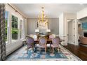 Elegant dining room with stylish decor, a large window, and a statement chandelier at 4823 Layfield Dr, Atlanta, GA 30338