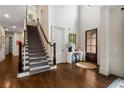 Spacious foyer with hardwood floors, a grand staircase, and a view of the front door at 4823 Layfield Dr, Atlanta, GA 30338