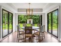 Bright dining area with hardwood floors, large french doors and modern light fixture at 4823 Layfield Dr, Dunwoody, GA 30338