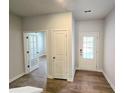 Bright entryway showcasing wood floors, white walls, and glass paneled doors at 670 Redhead Way (Lot 23), Grayson, GA 30017