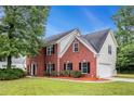 Lovely two-story brick home with manicured lawn and attached two-car garage at 602 Jules Crest Ct, Lawrenceville, GA 30045