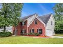 Beautiful two-story home featuring brick and siding with a well-manicured lawn at 602 Jules Crest Ct, Lawrenceville, GA 30045