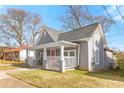 Charming gray home with a welcoming front porch on a sunny day at 1091 Longley Nw Ave, Atlanta, GA 30318