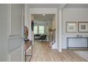 Inviting entryway with wood-look flooring, console table, and glimpses into the living spaces at 1109 Georgian Point Dr, Lawrenceville, GA 30045