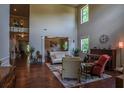 Spacious living room with soaring ceilings, hardwood floors, and a piano at 1185 Gallatin Way, Suwanee, GA 30024
