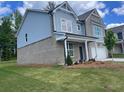 Angle view of brick two-story home with well manicured lawn and two-car garage at 376 Collier Mills Rd Dr, Lawrenceville, GA 30045
