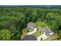 Overhead aerial shot of two gorgeous homes surrounded by lush greenery and mature trees at 4383 Capstone Ne Ct, Roswell, GA 30075