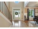 Inviting foyer with hardwood floors, staircase, elegant trim, and natural light pouring through the front door at 4383 Capstone Ne Ct, Roswell, GA 30075