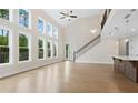 Bright living room boasting soaring ceilings, large windows, and hardwood flooring at 527 Pearl St, Cumming, GA 30040