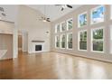 Expansive living room featuring a vaulted ceiling, a fireplace, and abundant natural light at 527 Pearl St, Cumming, GA 30040