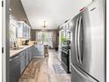 Well-equipped kitchen features stainless steel appliances, granite countertops, and ample cabinet space at 995 Chimney Trace Way, Lawrenceville, GA 30045