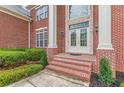 Close up view of brick porch with double door entry and white pillars at 270 Annelise Park Dr, Fayetteville, GA 30214