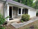 The house features a front entrance with stone accents and a white two-car garage at 2705 Rhoanoke Dr, Duluth, GA 30096