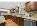Well-lit kitchen with stainless steel appliances, granite countertops, and hardwood floors at 4608 Rosemear Ct, Norcross, GA 30093