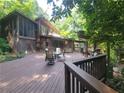 Inviting exterior showcasing a beautiful deck with outdoor seating and wooded surroundings at 605 Ga 120 Hwy, Roswell, GA 30075