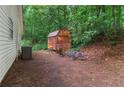 View of backyard shed alongside house, with potential storage and recreational space at 2865 Chattahoochee Rd, Cumming, GA 30041