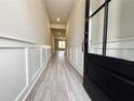 Welcoming entryway with stylish paneled walls, wood-look flooring, and ample natural light at 5702 Urban Village Way # 2, Tucker, GA 30084