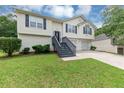 Charming split-level home with inviting entrance, two-car garage and manicured lawn at 2880 Field Spring Dr, Lithonia, GA 30058