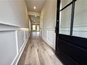Inviting foyer boasts fresh paint, decorative wainscoting, and stunning wood-look flooring at 5700 Urban Village Way # 1, Tucker, GA 30084