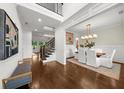 Inviting foyer with high ceilings, staircase with iron railing, and access to the dining room and living room at 885 Old Peachtree Ne Rd, Lawrenceville, GA 30043