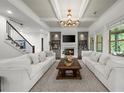 Bright living room with fireplace, built-ins, modern lighting, and staircase access at 885 Old Peachtree Ne Rd, Lawrenceville, GA 30043