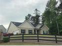 Well maintained, bright, single-story home featuring black shutters and a wooden fence at 100 Ruby Ln, Mcdonough, GA 30252