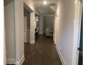 Inviting hallway showcasing hardwood floors and neutral paint leading to the living areas at 100 Ruby Ln, Mcdonough, GA 30252
