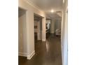 Inviting hallway showcasing hardwood floors and neutral paint leading to the living areas at 100 Ruby Ln, Mcdonough, GA 30252