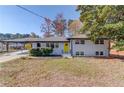 Charming single-Gathering home with a well-maintained front yard and bright yellow front door at 2103 Columbia Dr, Decatur, GA 30032