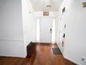 Bright entryway with hardwood floors and a classic white front door at 2840 General Lee Way, Buford, GA 30519