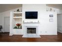 Living room featuring a marble fireplace and built-in shelving at 2840 General Lee Way, Buford, GA 30519
