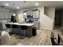 Spacious kitchen features gray cabinets, a large island, stainless steel appliances, and hardwood flooring at 7621 Gray Pointe Dr, Lithonia, GA 30058