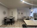 Open-concept living area featuring a dining table, contemporary decor, and hardwood flooring at 7621 Gray Pointe Dr, Lithonia, GA 30058