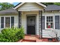 Close-up of the charming front porch with decorative ironwork and brick steps at 1377 Pine Ave, Atlanta, GA 30344