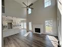 Bright living room with high ceilings, fireplace, wood floors and seamless flow into a modern, stylish kitchen at 479 Rising Sun Path, Lawrenceville, GA 30043