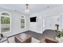 Inviting living area with plush seating, modern lighting, and views of the outdoors at 6150 Bridge Fair Rd, Cumming, GA 30028