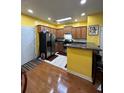 Bright kitchen features wooden cabinets, stainless steel appliances, and a breakfast bar, perfect for casual dining at 2366 Bigwood Trl, Atlanta, GA 30349