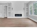 Bright living room featuring a modern fireplace, built-in shelving, and large windows for natural light at 3312 Mill Forest Dr, Conyers, GA 30094